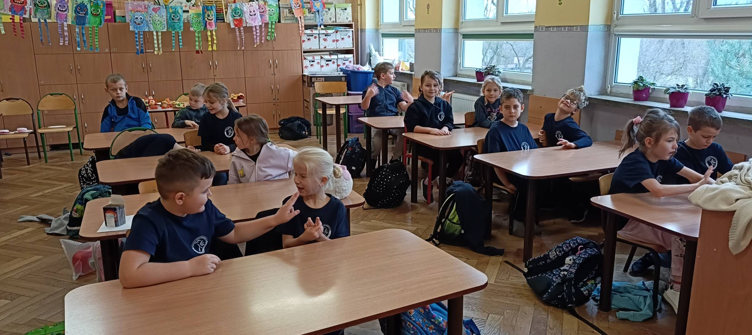 Dzieci pracują w ławkach na zajęciach patriotycznych