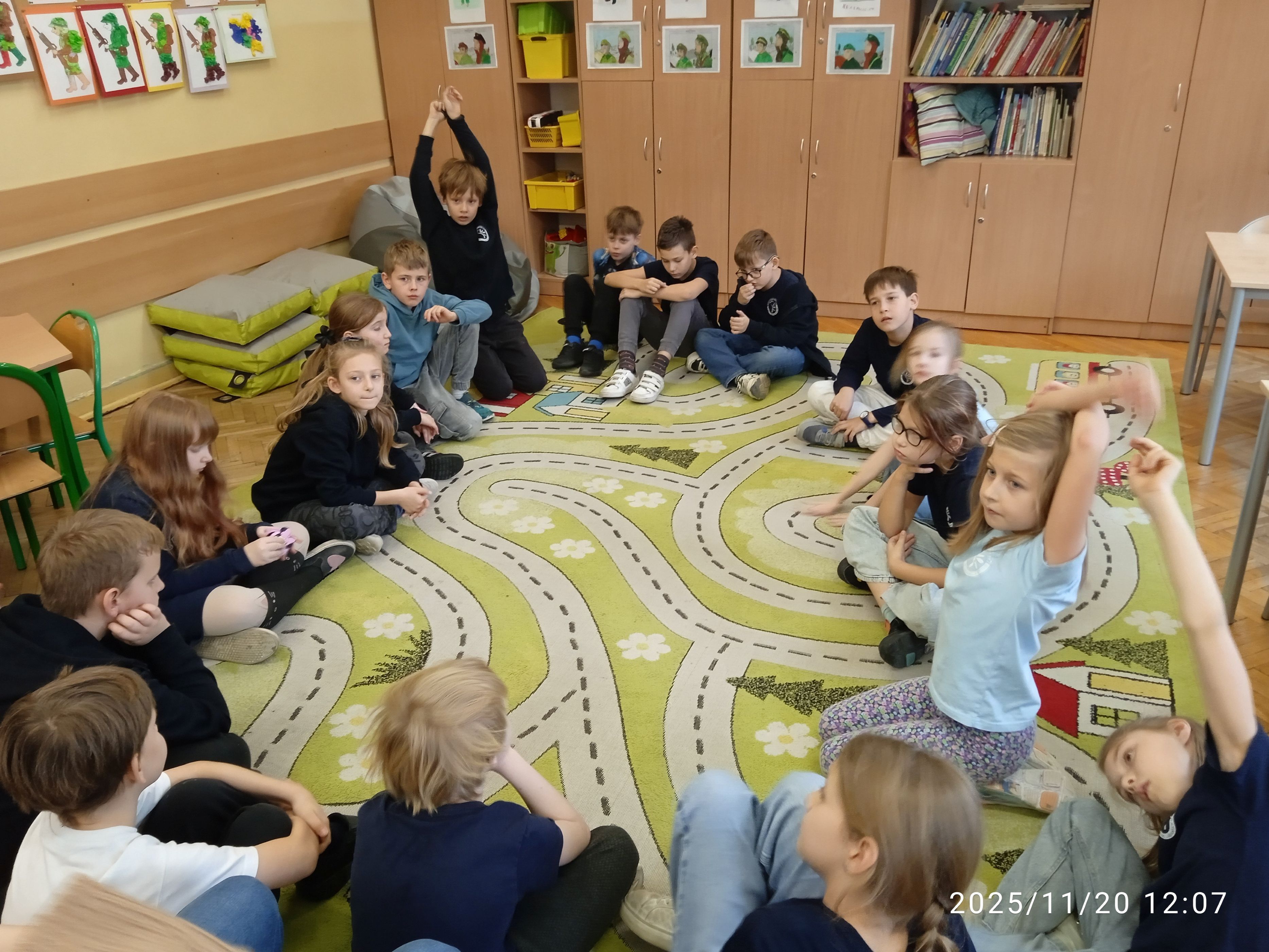 Uczniowie siedzą w kole