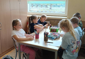 Dzieci wykonują pracę plastyczną z animacji