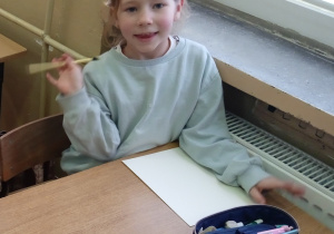 Uczennica siedzi w ławce