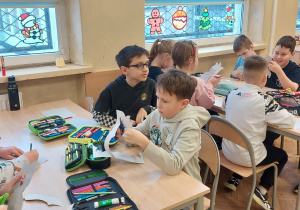 Uczniowie pracują przy stolikach