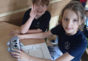 Uczniowie siedzą przy stoliku