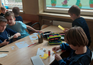Uczniowie pracują przy stoliku