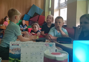 Dzieci oglądają prezentację o znanych miejscach w mieście Łodzi