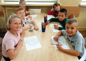 Uczniowie siedzą przy stoliku