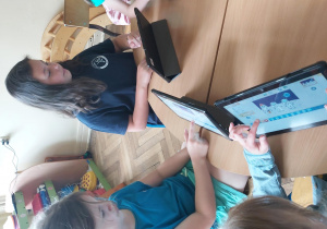 Uczniowie pracują na tabletach, tworzą aplikację w programie Scratch Junior.